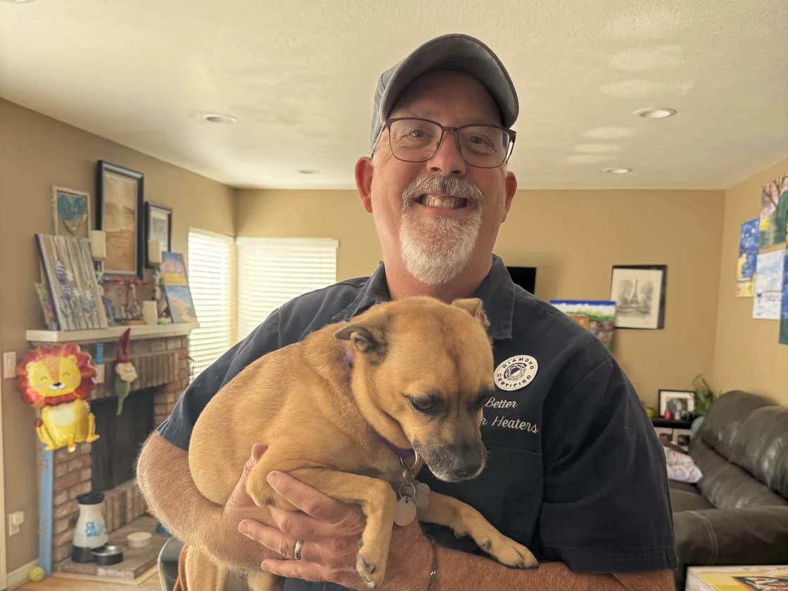Frans from Better Water Heaters holding a dog