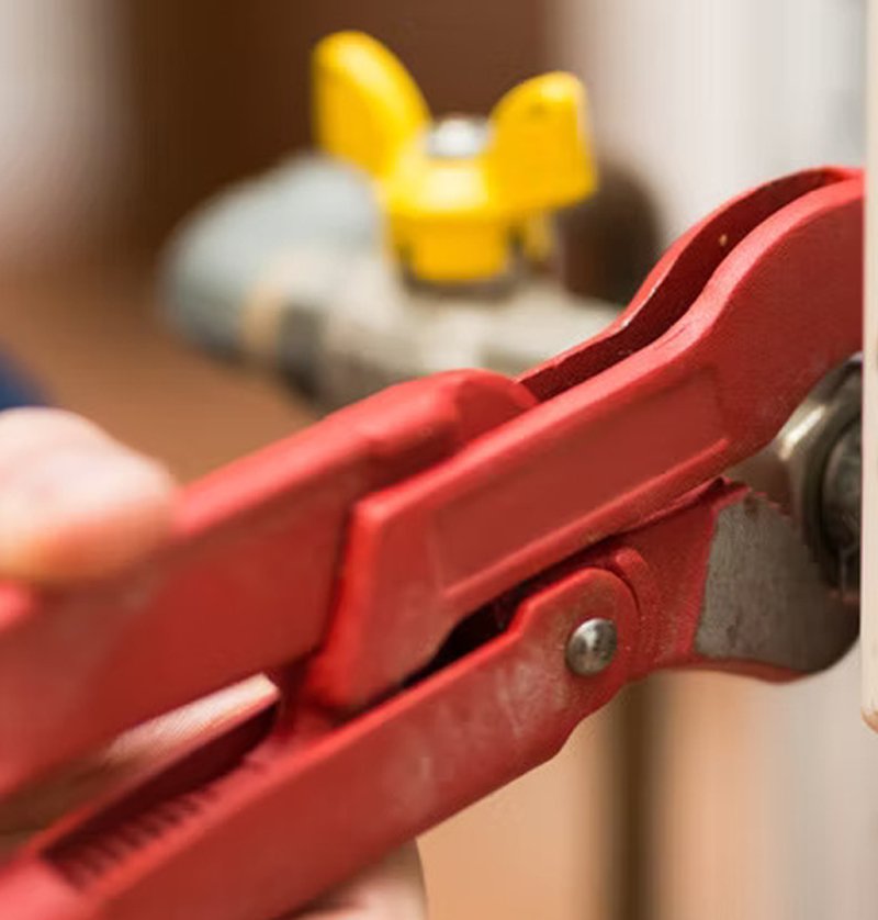Technician installing a modern tank water heater for a Bay Area homeowner