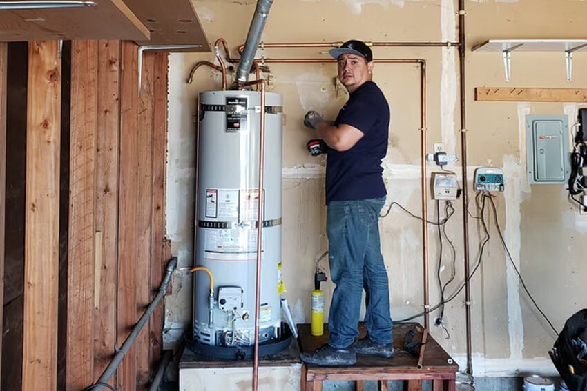 Licensed technician installing a residential water heater in San Jose, California